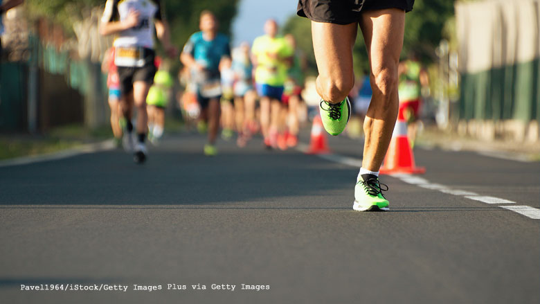 Photo of the legs of runners on a track